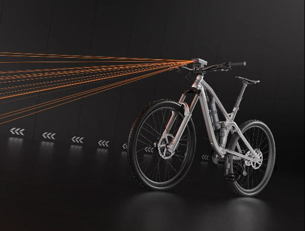 Bicycle with light beam projection on a dark background